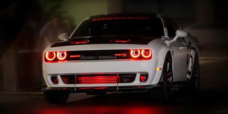 white Dodge Challenger with red lights and black hood